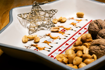 Hazaknuts and nuts on the plate with bright star