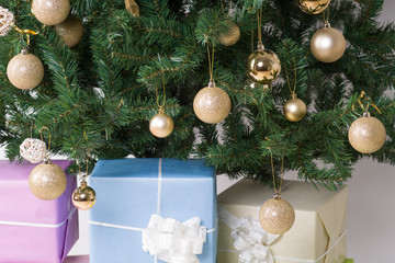 Christmas gifts in front of Christmas tree