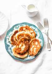 Potato fritters - delicious breakfast, snack on a light background, top view