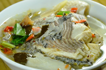 spicy boiled Tilapia fish in tom yum soup on bowl