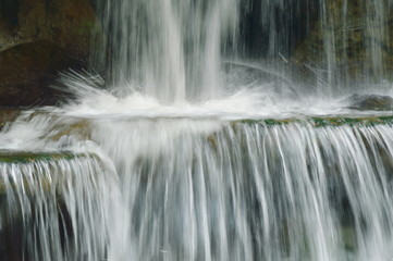 waterfall on river pass rock and stone in forest