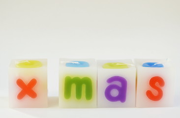 Fototapeta premium candle arranging X Mas word on white background