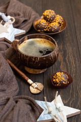 Fototapeta na wymiar A cup of black coffee with chocolate truffles. Homemade fresh truffle dark chocolate candies with a cup of coffee. Copy space.