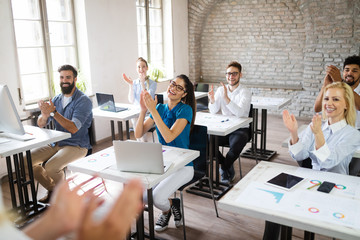 Successful happy group of people learning software engineering and business during presentation