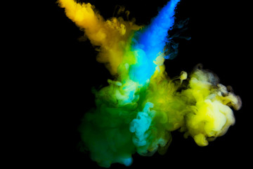 paint cloud in water, abstract background, process of mixing multicolored dye on a black background