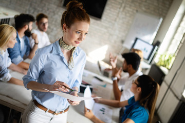 Startup business team on meeting in modern bright office interior brainstorming, working on computer