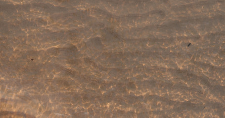 waves at sunset with caustics