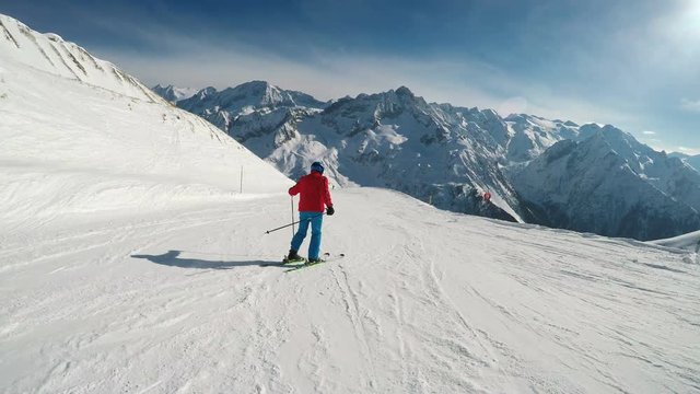 Man skiing on the prepared slope with fresh new powder snow in Italian Alps, Tonale
