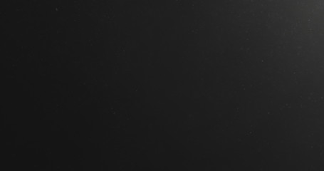 dust particles flow from bottom on black background
