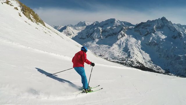 Man skiing on the prepared slope with fresh new powder snow in Italian Alps, Tonale
