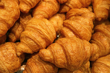 Heap of fresh baked mouthwatering butter croissant pastries 