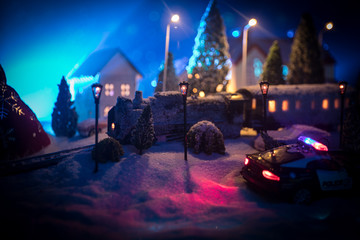 Miniature of winter scene with Christmas houses, train station, trees, covered in snow. Nights scene. New year or Christmas concept.