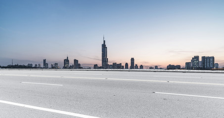 Fototapeta na wymiar Panoramic skyline and buildings with empty road 