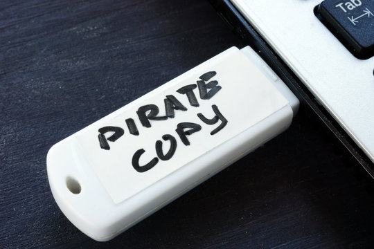 Pirate copy written on a flash drive. Copyright law.