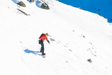 Chamonix de Mont Blanc, France, December 24, 2015. A snowboarder wearing a bright red vest...