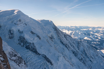 View over the French Alps, from the Aiguille du Midi cable on a winter afternoon, just before Christmas.