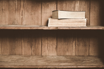 Naklejka na ściany i meble Old books on a wooden shelf