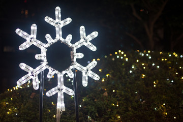 Christmas night light in snowflake shape for decoration in public park.