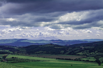 Panoramic view of the italian tuscany. The mountains in the distance are covered by clouds.