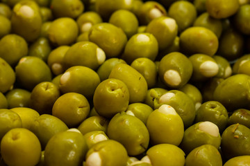 Numerous stuffed olives in the market for sale.