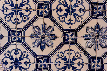 Close view of several white and blue tiles with decorative guards.