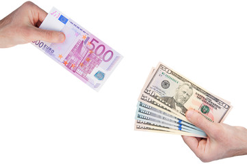 Hands with 500 euro and 50 100 dollars banknotes isolated on white background. Money exchange concept. Diagonal view.