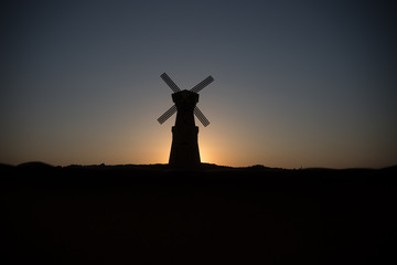 Fototapeta na wymiar Traditional, Dutch windmill at a hill during a summer sunset. Decoration.