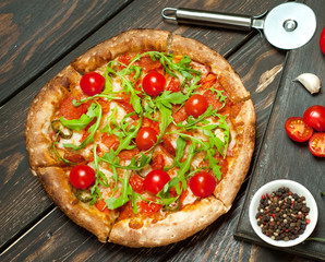 pizza on wood table with ingredients