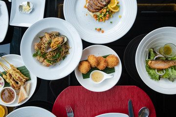 table with food, top view, Fish and meat meals variety flat lay. buffet with assortment of healthy hearty food, appetizer, restaurant menu concept