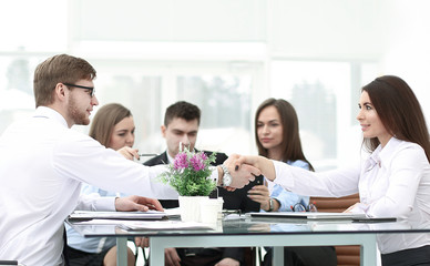 handshake of business partners on a Desk in the office