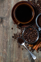 roasted coffee beans and spices on dark wooden background, concept photo, vertical closeup