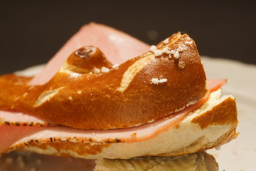 Fresh pretzel with sausage and cheese is a tasty snack