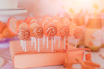 set of orange  lollipops, children's candies
