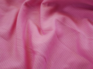 Fototapeta na wymiar pink sportswear cloth texture background,silk fabric texture,pink background