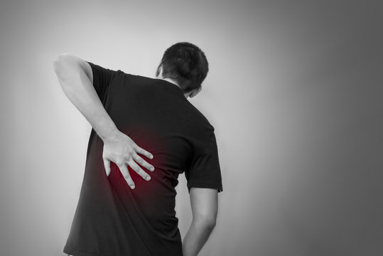 Man man touching his back for back pain, spine disease