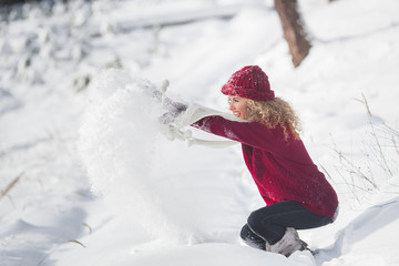Young beautiful woman having fun in winter time outdoors
