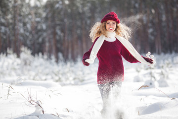 Young beautiful woman having fun in winter time outdoors