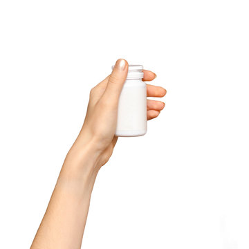 Female Hand Holding A Plastic Pill Bottle, Isolated On White