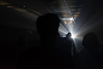 white light ray in the underground with shadow of people
