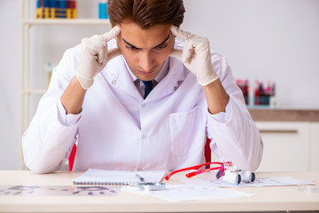 Forensic expert studying fingerprints in the lab