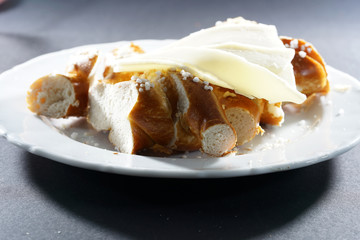 Fresh pretzel with sausage and cheese is a tasty snack