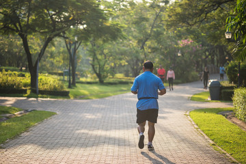 Senior fat man run in park