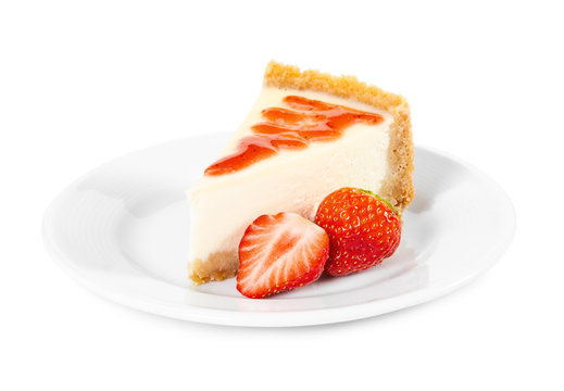 Piece of cheesecake with fresh strawberries on white plate