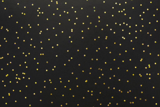 Festive Texture With Golden stars on black background