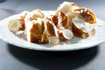 Fresh pretzel with sausage and cheese is a tasty snack