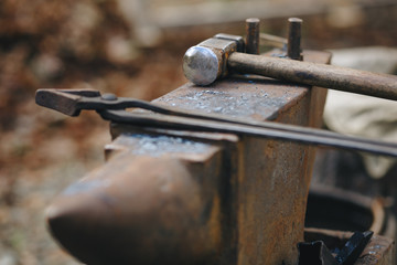 blacksmith's anvil on the street with hammer and tongs.
