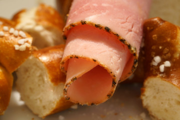 Fresh pretzel with sausage and cheese is a tasty snack