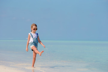 Adorable little girl at beach during summer vacation