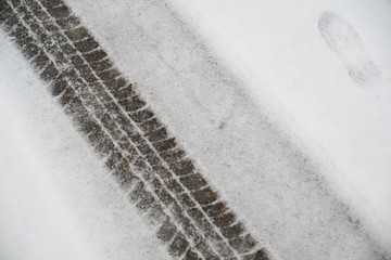 Tire tracks in the snow, winter tire footprint.