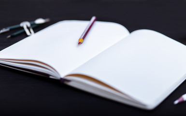 Back to school concept, colored pencils on black table, multicolored stationery accessories for educator teaching kid drawing on empty wooden desk, creative education background, top view, copy space